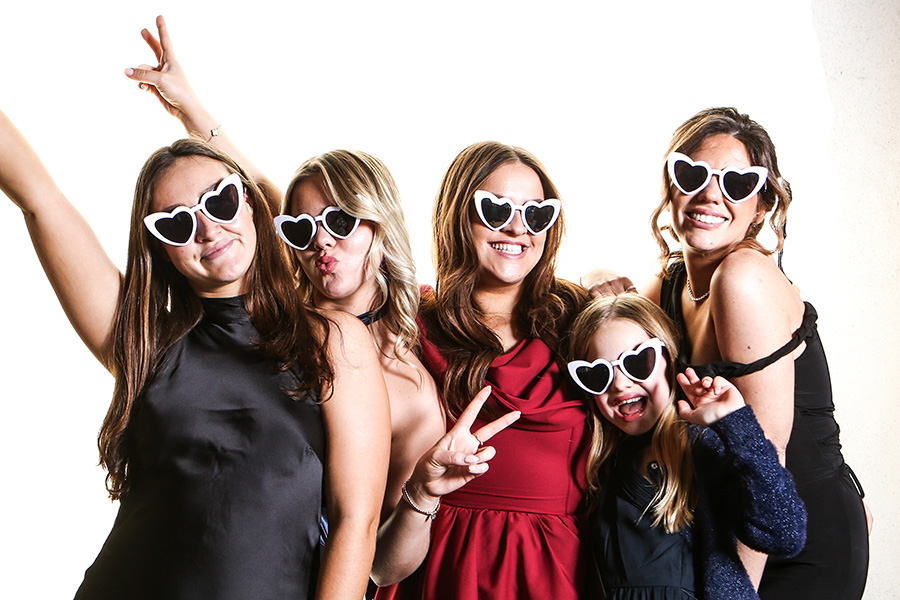Wedding guests having fun in a studio-style photo booth at a Dorset wedding